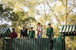 Students and teacher from Shakarganj Evergreen School standing together during an educational outing in a public park.
